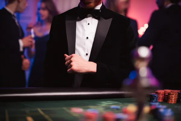 A young woman relaxing with her phone while dynamic casino elements float around her, illustrating the smooth mobile experience offered by the 777JAYA app.