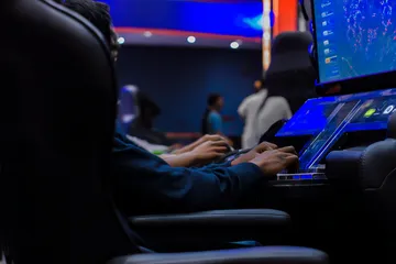 A laptop glowing with a bright login prompt in a minimalistic setup, symbolizing the protected access system at 777JAYA.
